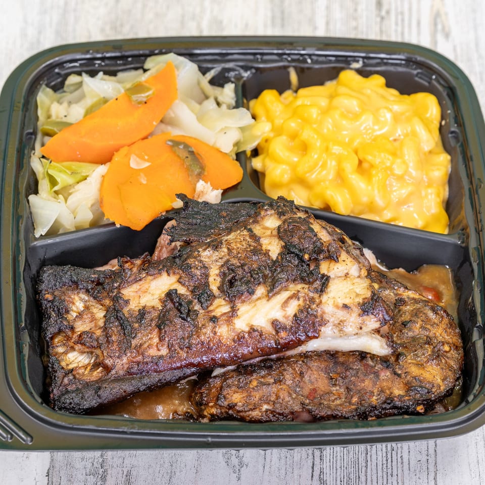 St. Bess Jerk meal with jerk fish, mac and cheese, and steamed cabbage with carrots.