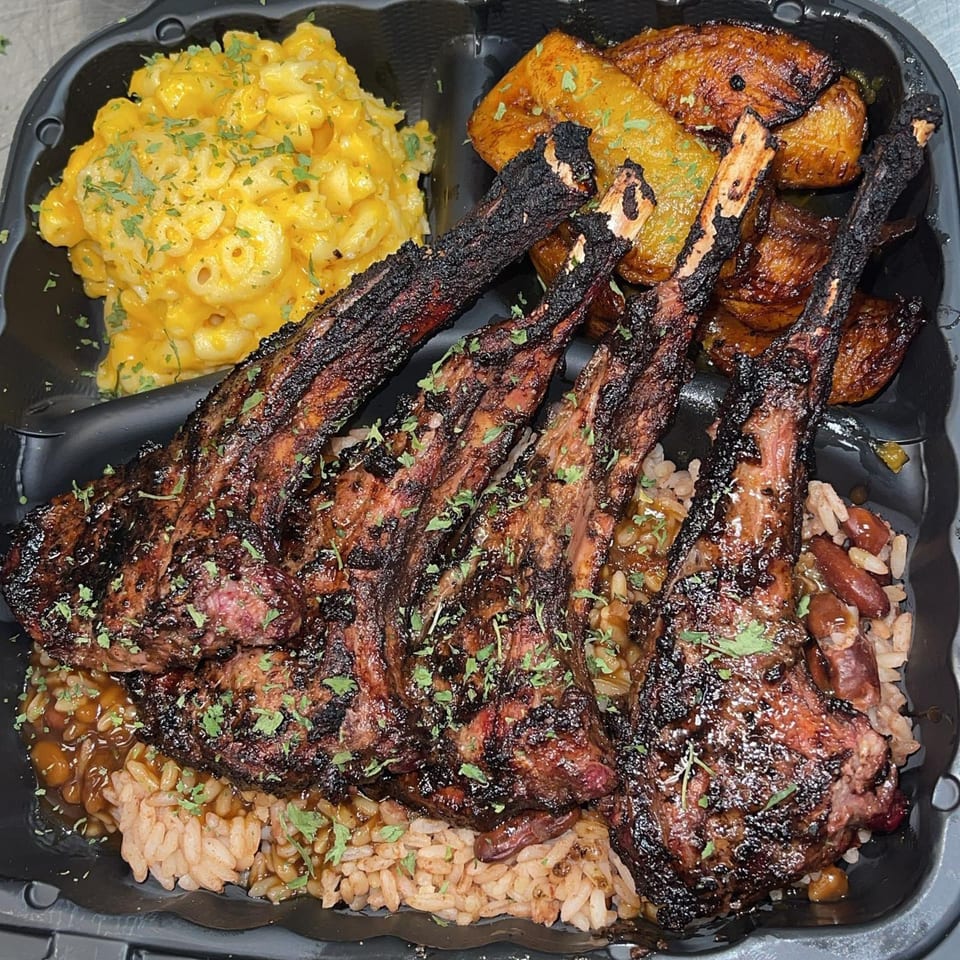 St. Bess Jerk's Jamaican meal with grilled lamb chops, rice and peas, mac and cheese, and plantains.