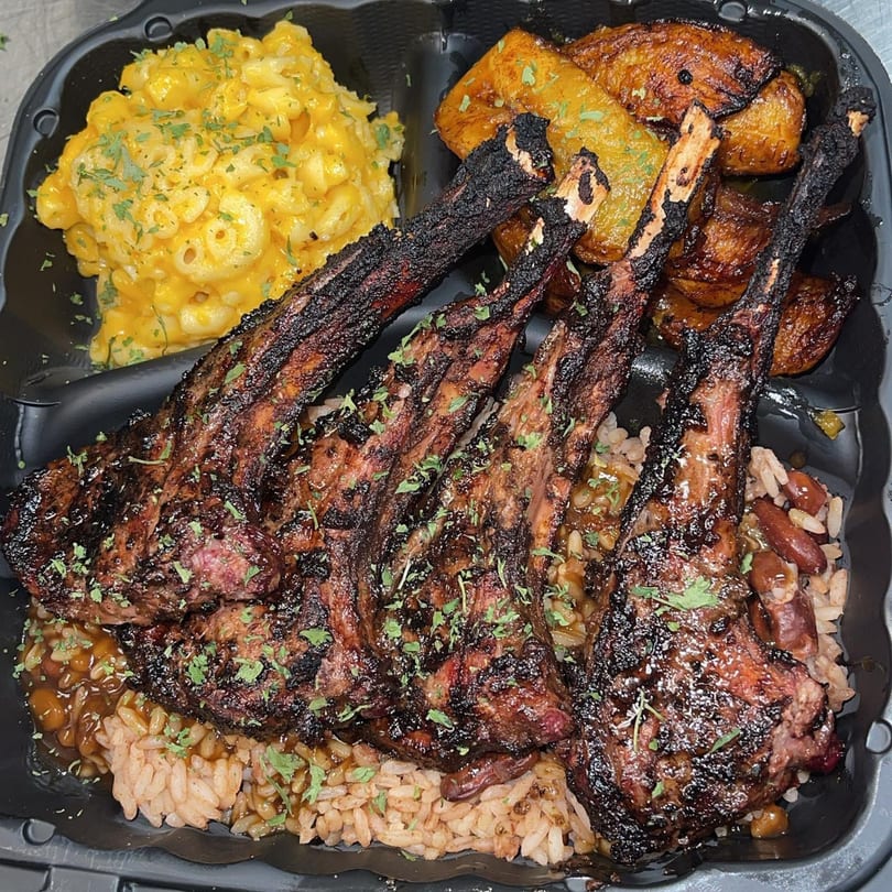 St. Bess Jerk's Jamaican meal with grilled lamb chops, rice and peas, mac and cheese, and plantains.